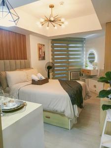 a bedroom with a bed and a ceiling fan at Sam's Chic Space - An Aesthetic Getaway in Angeles +12 photos