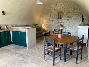 a kitchen and dining room with a table and chairs at Le Mas du Rochet - Gîte à la campagne avec spa privé - 2 à 4 pers in Mirmande +14 photos