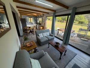 a living room with a couch and a table at Highbourne Cottages in Winterton
