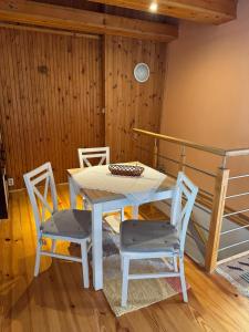 a table and chairs in a room with a bed at Apartman Ala in Poprad +7 photos