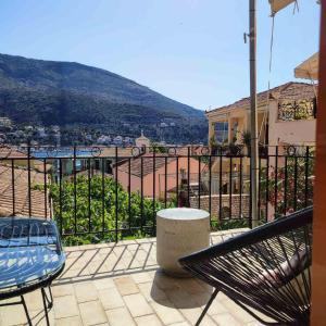 a balcony with a bench and a view of a city at Maroudas Stavros Apartments in Vathi +22 photos