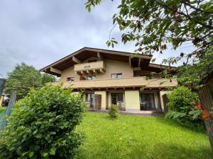 a house with a green lawn in front of it at Haus Imbachhorn Summer Card included in Zell am See