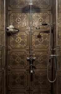 a bathroom with a large wooden door with a shower at Regal House Anzio Terrazzo in Anzio +41 photos