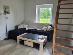 a living room with a couch and a table at Gîte à Romagné in Romagné