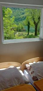 a bedroom with a window with a bed and a view at VISIT BORACKO LAKE Apartment doelend in Jezero