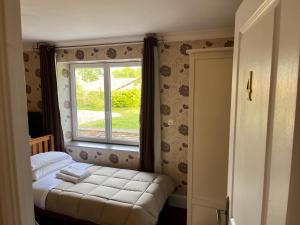 a small bedroom with a bed and a window at Le Pontet in Miramont-de-Guyenne +92 photos