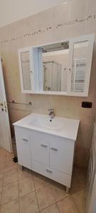 a bathroom with a white sink and a mirror at Domus Le Palme in Fano +42 photos