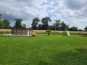 a park with a playground and a swing set at Gîte à Romagné in Romagné