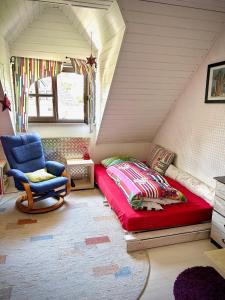 a bedroom with a bed and a chair in a attic at Einzelzimmer Nürnberg Fischbach in Nürnberg