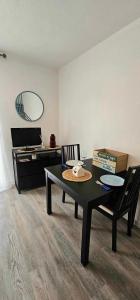 a room with a table and chairs and a piano at La CAMPA CAZALINE in La Teste-de-Buch +2 photos