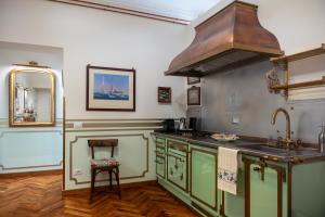 a kitchen with a sink and a stove top oven at Regal House Anzio Manetti 16 in Anzio