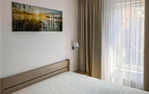 a bedroom with a bed in front of a window at 1 Bedroom Stunning Apartment In Mielno in Mielno