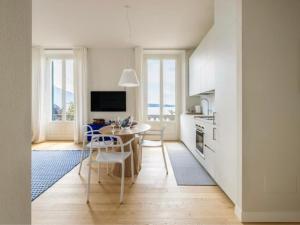 a kitchen and dining room with a table and chairs at Beccherie 90 in Verbania