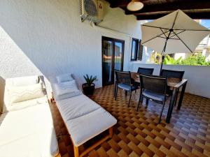 eine Veranda mit einem Bett, einem Tisch und Stühlen in der Unterkunft Villa Aleksandar Porec in Poreč