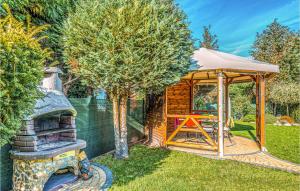 a gazebo and a grill in a yard at 5 Bedroom Stunning Home In Grzybowo in Grzybowo