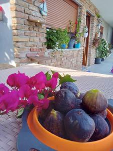 a bowl of fruit and flowers on a table at VILA PASHA in Sarandë