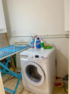 a washing machine with cleaning products on top of it at B&B La Casa Di Tufo in Orvieto
