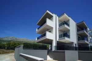 a white building with balconies on the side of it at Villa BILA in Podstrana