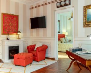 a living room with a red chair and a fireplace at Regal House Anzio Terrazzo in Anzio