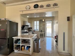a kitchen with a sink and a refrigerator at maison cosy et chic in Plancy