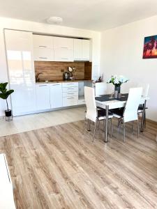 a kitchen and dining room with a table and chairs at Summer Apart Janet in Obzor +30 photos
