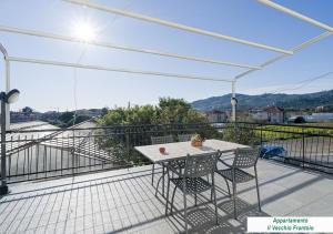 a patio with a table and chairs on a balcony at Agriturismo Le Girandole in Diano Marina