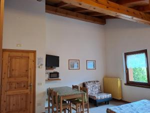 a room with a table and a chair and a window at Residence Iris BeB in Valdisotto