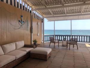 a living room with a couch and a view of the ocean at Casa Esmeralda in Colán