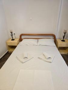 a bed with two napkins on top of it at Sunny Home II in Ermioni