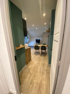 a hallway with a dining room and a table at Appartement l antre deux vignes in Saulchery