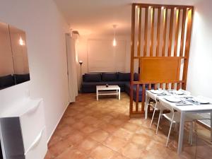 a living room with a table and a couch at Appartement Familial - CaboNegro in Cabo Negro
