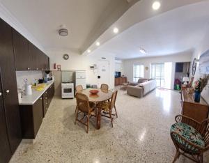 a kitchen and living room with a table and chairs at Side Seaview St Pauls Bay Apartment in St. Paul's Bay