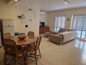 a living room with a table and a couch at Side Seaview St Pauls Bay Apartment in St. Paul's Bay