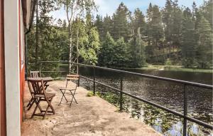 a porch with a table and chairs and a lake at 2 Bedroom Awesome Home In Frövi in Frövi