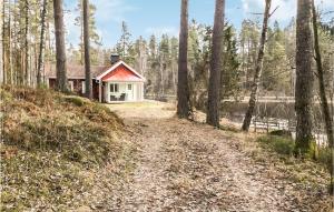 a house in the woods next to a dirt road at 2 Bedroom Awesome Home In Frövi in Frövi