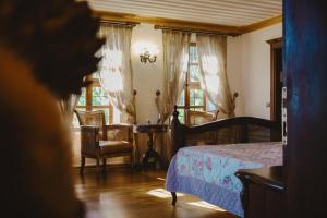 a bedroom with a bed and a table and chairs at Konak Macha Boutique & Lounge Otel in Edremit