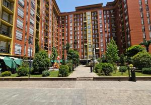 an empty street in front of a large building at Superb 1 bedroom in the best zone of the city. in Ferizaj