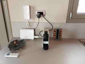 a counter with a cell phone and a phone charger at Costa Meganisi in Meganisi