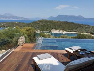a view of a swimming pool from the deck of a house at Costa Meganisi in Meganisi