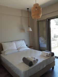 a bedroom with a bed with towels on it at Costa Meganisi in Meganisi +14 photos