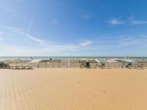 a group of bikes parked next to the beach at Cozy studio with pool close to the sea in Ostend +13 photos