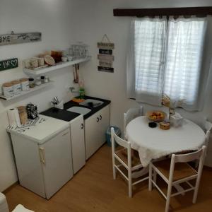a kitchen with a table and a stove and a sink at Apartman Mare BP in Dolac