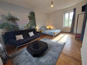a living room with a couch and a table at Gîte de la Vallée du Don in Guéméné-Penfao