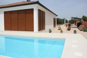 a swimming pool in front of a house at MEL'S HOUSE in Benkovac