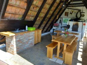 a kitchen with a table and a sink and a table and bench at Nyírfás Camping in Nagykanizsa
