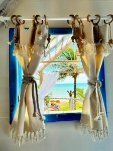 a window with a view of a beach at Raio de Sol Residence in Canoa Quebrada +57 photos