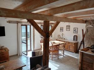 a kitchen with a table and a dining room at Domek Przyjacielówka Ekstra -Miejsce Ciszy in Sienna