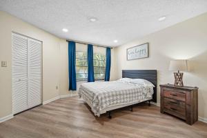 a bedroom with a bed and a dresser and a window at 3648 Orlando Vacational Apartment in Orlando +46 photos