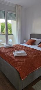 a bedroom with two beds with a laptop on it at Zira2 in Kotor