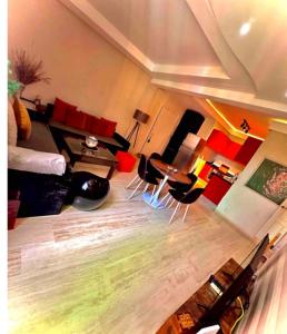 una sala de estar con un sofá, una mesa y sillas en Comme à la maison, en plein coeur de Marrakech, en Marrakech